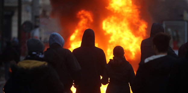 Flammen trennen AktivistInnen von der Polizei.  Foto: dpa