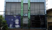 Broken windows are pictured at the Muslim-owned Fashion Bug store