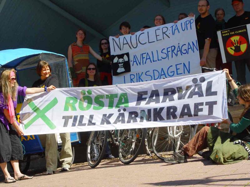 In the foreground a banner pointing to the "Vote Nuclear Power to History" campaign