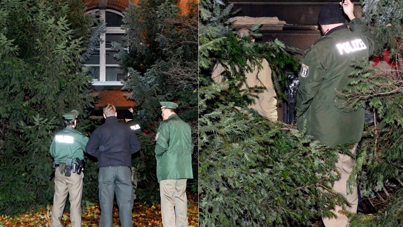 Links: Das Feuer beschädigte ein Fenster des Amts. Rechts: Ein Beamter bei der Spurensicherung