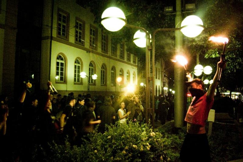 Fire juggler at a demonstration in Mainz, Germany.