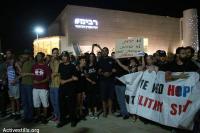 Israeli anti-war protesters stand with arms linked. via ActiveStills