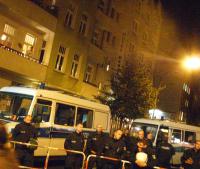 Neighbor of occupied hostel lights candles in solidarity