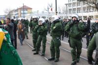 Während Ordner versuchen zu deeskalieren, ziehen die Polizisten ihre Helme auf